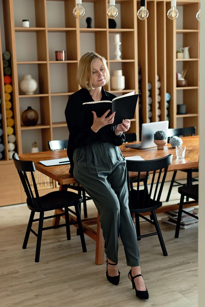 A professional woman reviewing a planner in an office setting