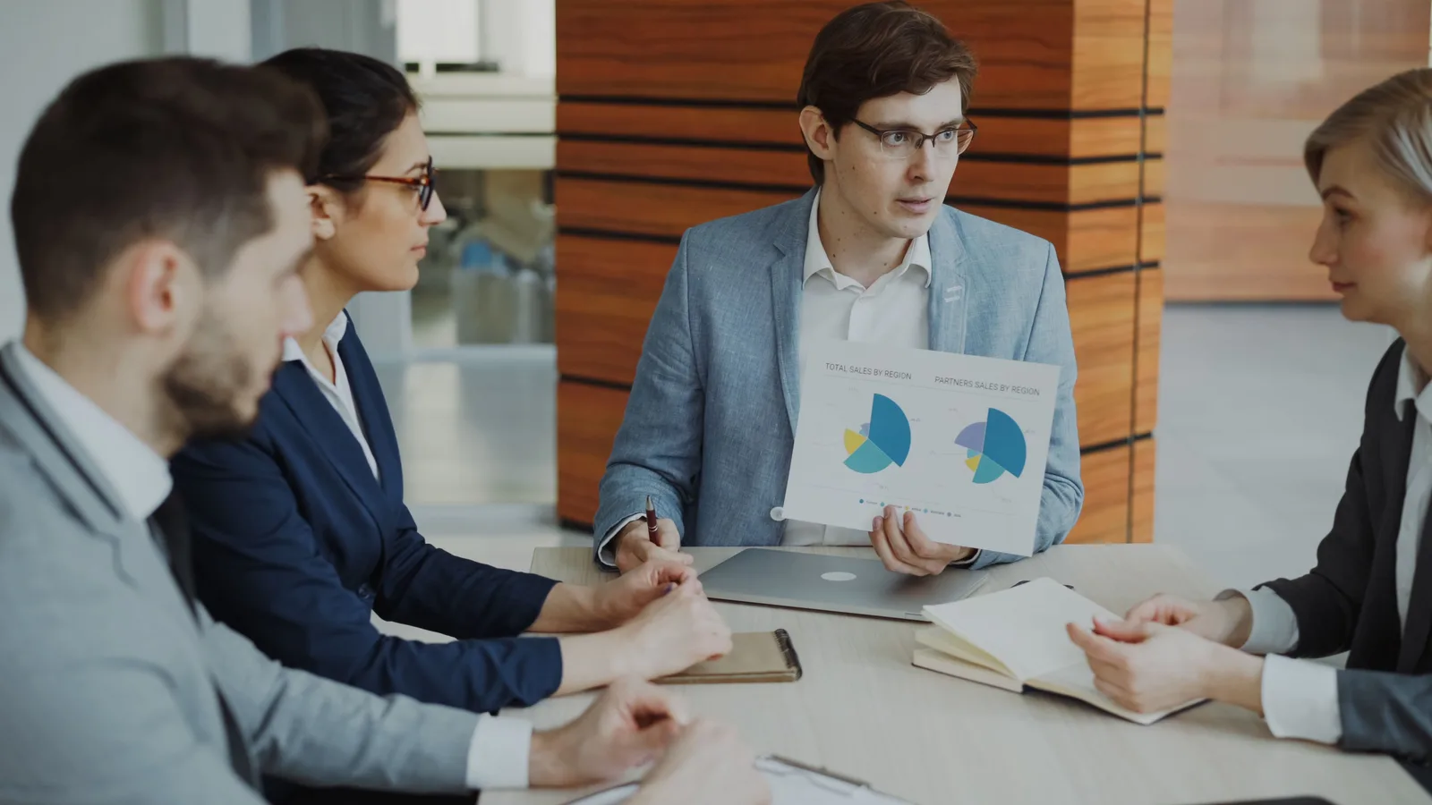 Professionals discussing business data and options during a team meeting