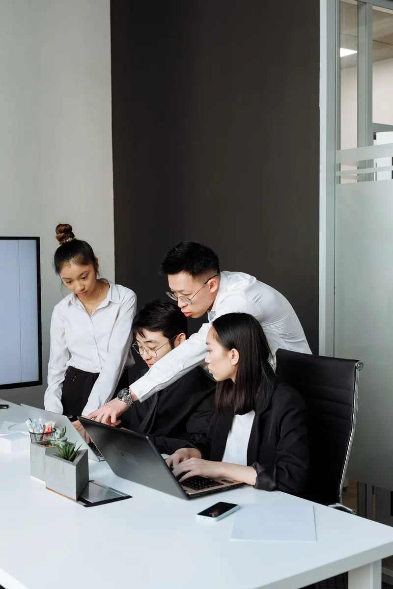 Business professionals reviewing information together on a laptop