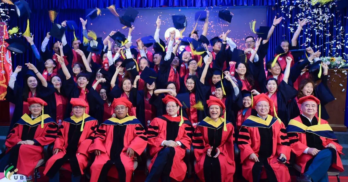Graduates and faculty celebrating with their caps in the air