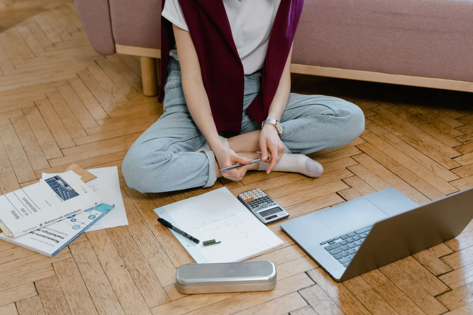 Student taking an online class on the floor